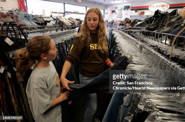 Nevius10_035_pc.jpg Dublin resident Sarah Wirag shops for blue jeans with her sister Amanda, 10. Shoppers browse the racks of used clothing at...
