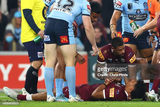 Selwyn Cobbo of the Maroons is attended to by Dane Gagai of the Maroons after a tackle during game three of the State of Origin Series between the...
