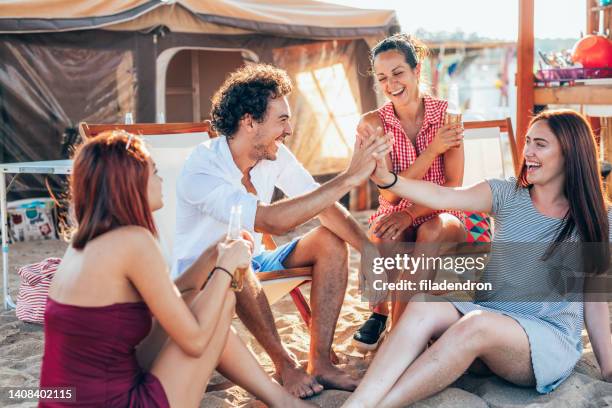 friends at a beach camp - male with group of females stock pictures, royalty-free photos & images