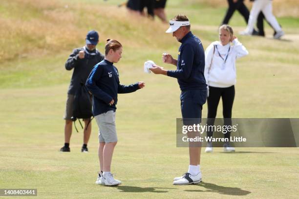 Ian Poulter of England signs an autograph during a practice round prior to The 150th Open at St Andrews Old Course on July 13, 2022 in St Andrews,...