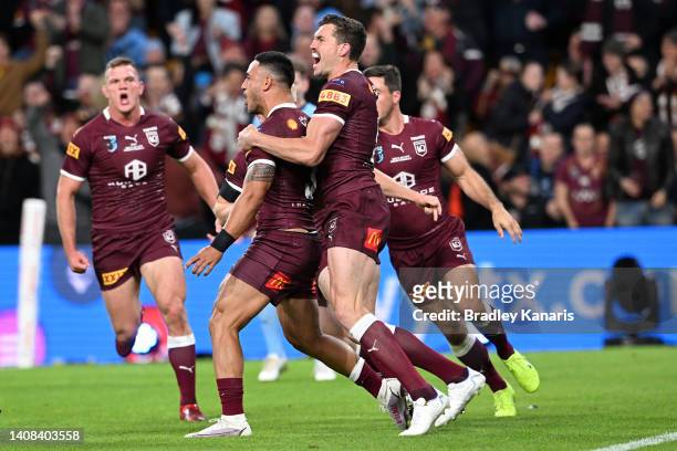 Valentine Holmes of the Maroons celebrates scoring a try with teammates during game three of the State of Origin Series between the Queensland...