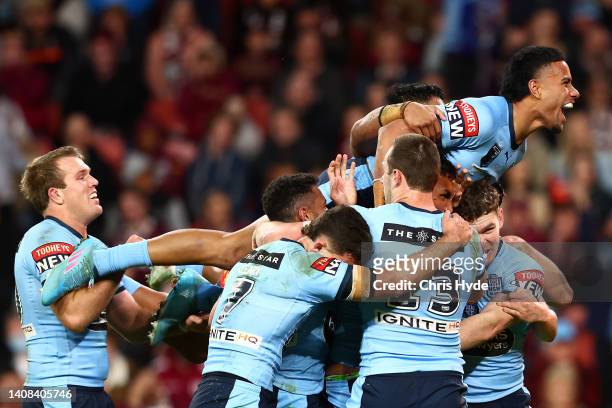 Stephen Crichton of the Blues celebrates with Jacob Saifiti of the Blues after he scored a tryduring game three of the State of Origin Series between...