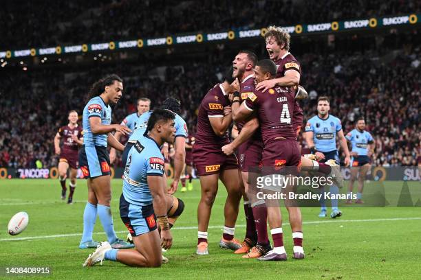 Kurt Capewell of the Maroons celebrates scoring a try with teammates during game three of the State of Origin Series between the Queensland Maroons...