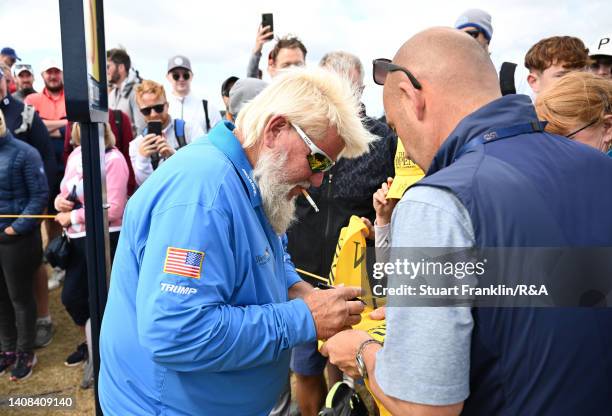 John Daly of the United States signs autographs on the 15th tee during a practice round prior to The 150th Open at St Andrews Old Course on July 13,...