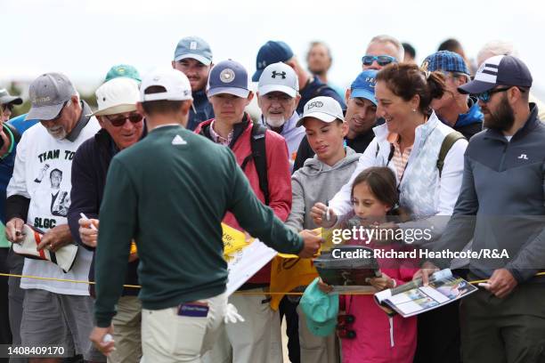 Collin Morikawa of the United States signs autographs during a practice round prior to The 150th Open at St Andrews Old Course on July 13, 2022 in St...