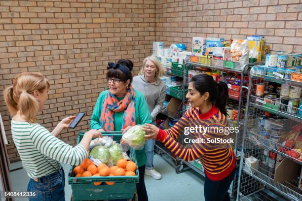 distributing food to the community - foodbanks for the needy stock pictures, royalty-free photos & images