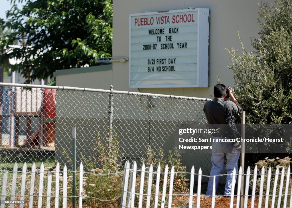 A news photographer takes pictures of a playground at Pueblo Vista