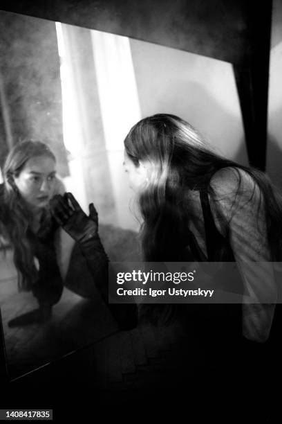 young mysterious woman reflected in mirror - mirror steam stock pictures, royalty-free photos & images