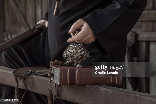 handsome redhead cowboy priest with an owl in an authentic wild west setting - animal macho 個照片及圖片檔