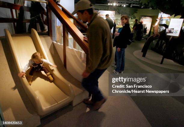 Riley Neikirk slips down a slide as her dad Dana watches at the new Wild About Otters exhibit at the Monterey Bay Aquarium in Monterey, Calif. On...