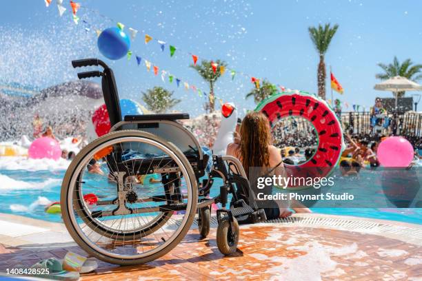 disabled female by a swimming pool with  inflatable donut - hot women on boats stock pictures, royalty-free photos & images