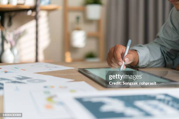 young man using pen and tablet - investment research stock pictures, royalty-free photos & images