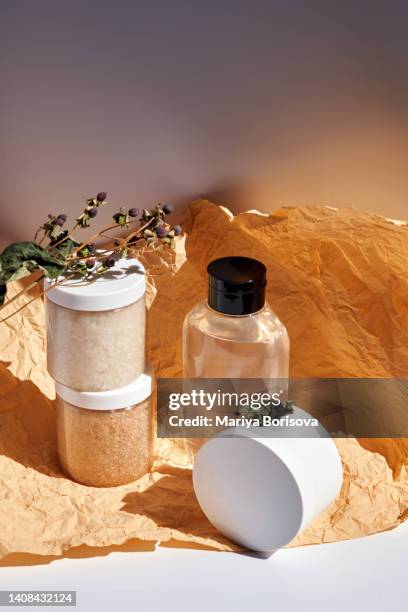 two jars of scrub and shower gel or shampoo on a yellow-brown background. - coco brown imagens e fotografias de stock