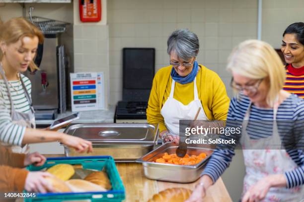 preparing the vegetables for the soup kitchen - woman cooking stock pictures, royalty-free photos & images