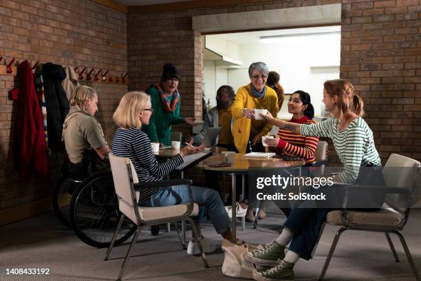 meeting at the community centre - community imagens e fotografias de stock