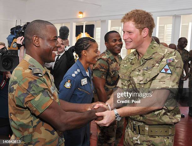 Prince Harry meets fellow Sandhurst trainee cadet Lieutenant Kayon Mills during his visit to the Up-Park Camp on March 7, 2012 in Kingston, Jamaica....