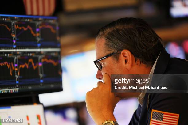 Traders work on the floor of the New York Stock Exchange during morning trading on July 13, 2022 in New York City. The stock market opened on a low...