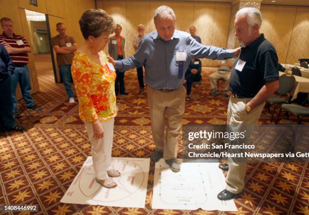 Discussion leader Sherod Miller, center, guides Audrey Hubbard, left, and her husband Dee Jay through an exercise in the Couple Communication...