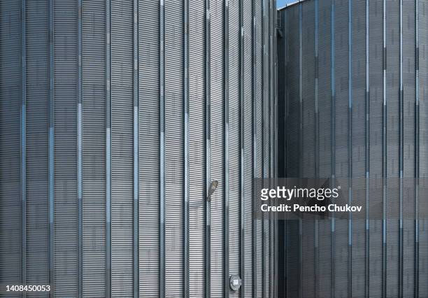 close up view of huge, shining agricultural grain silos. agricultural occupation. global business. industrial led street lamp on a silo. - tone tank stock pictures, royalty-free photos & images