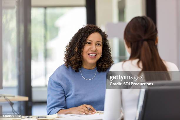 female co-workers meet to brainstorm ideas for presentation - performance evaluation stock pictures, royalty-free photos & images