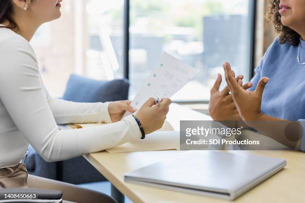 unrecognizable woman gestures while describing work experience in interview - performance evaluation stock pictures, royalty-free photos & images
