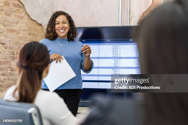 female manager uses large screen to present spreadsheet - spreadsheet stock pictures, royalty-free photos & images