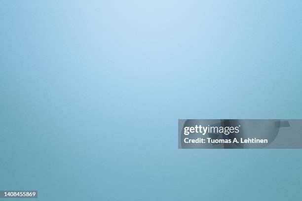 light blue or turquoise textured paper background with light effect. copy space. - light blue foto e immagini stock