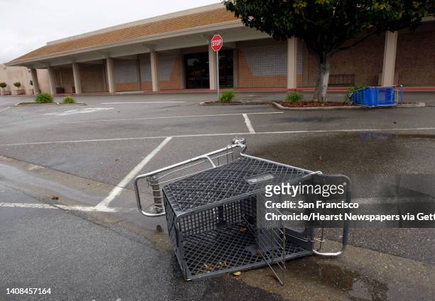 Shopping carts lie on their side in the abandoned parking lot in front of a shuttered Mervyn's department store in Dublin, Calif., on Saturday, May...