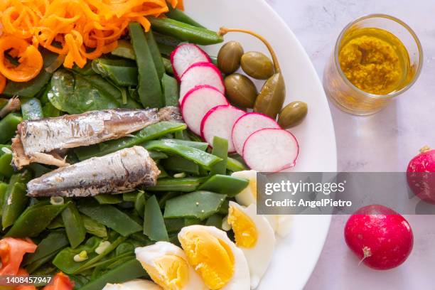 salat with canned sardines and a mix of vegetables - radish vinaigrette stock pictures, royalty-free photos & images