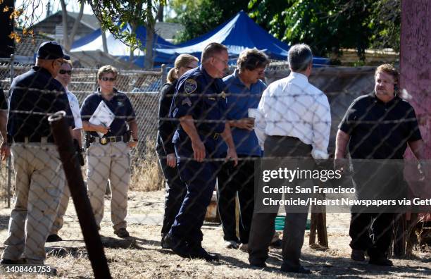 Authorities confer before continuing their search for evidence in the backyard of a next door neighbor of Phillip Garrido near Antioch, Calif., on...