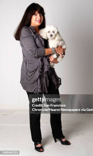 Lynn Goldfinger and her toy poodle Vito are seen in San Francisco, Calif., on Saturday, Nov. 6, 2009. Goldfinger sells eclectic antiques online.