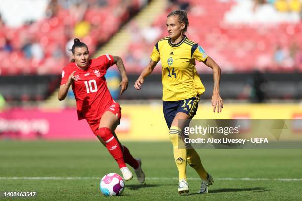 Nathalie Bjorn of Sweden runs with the ball whilst under pressure from Ramona Bachmann of Switzerland during the UEFA Women's Euro 2022 group C match...