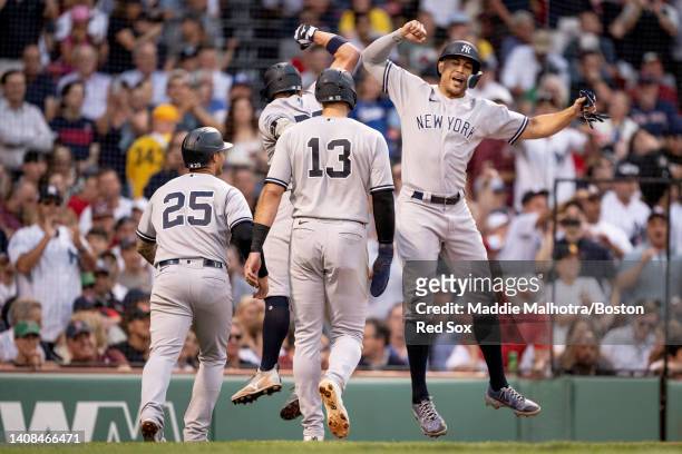 Josh Donaldson of the New York Yankees reacts with Giancarlo Stanton of the New York Yankees after hitting a grand slam during the third inning of a...