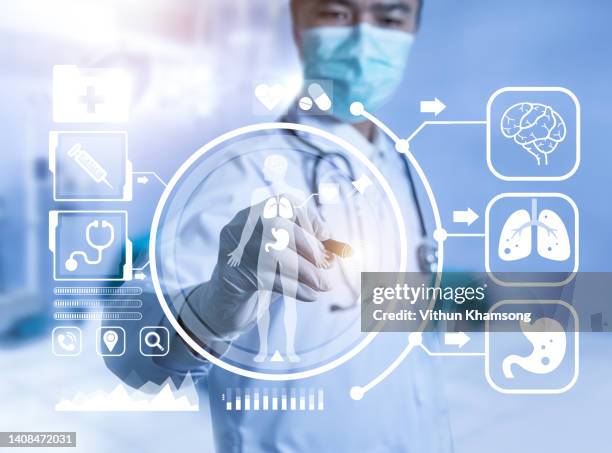 doctor analyzing human body on technological digital futuristic virtual interface - tecnología sanitaria fotografías e imágenes de stock