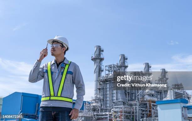 male asian engineer working at heavy industrial factory or power plant - boiler engineer stock-fotos und bilder