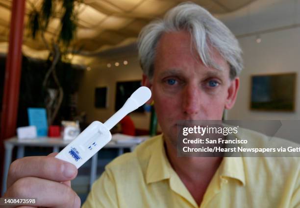 Steve Gibson, director of the Magnet HIV testing clinic, holds a rapid HIV antibody test wand that patients swipe inside their mouths, in San...