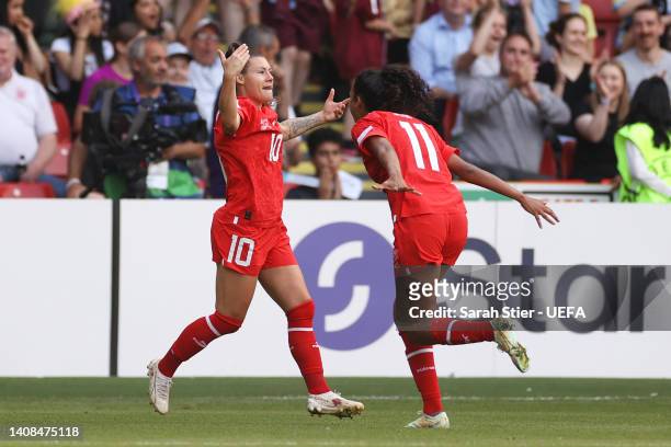 Ramona Bachmann celebrates with Coumba Sow of Switzerland after scoring their team's first goal during the UEFA Women's Euro 2022 group C match...