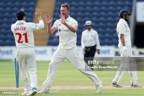 Michael Hogan of Glamorgan celebrates with teammate Andrew Salter after bowling out Haseeb Hameed of Nottinghamshire during the LV= Insurance County...