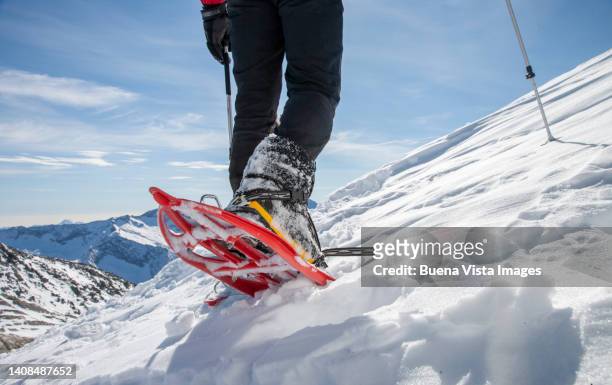 climber on a snowy slope - schneeschuh stock-fotos und bilder