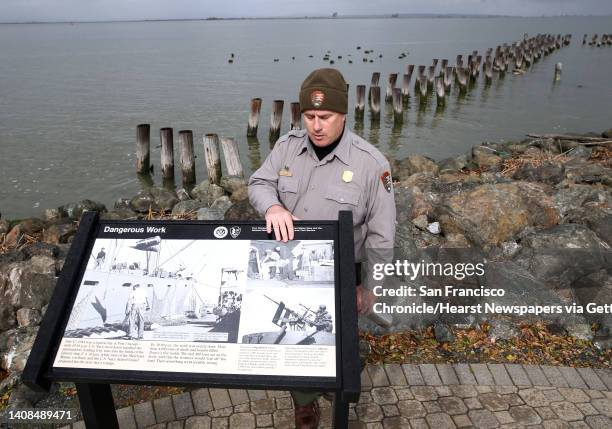 National Park Service ranger Tad Shay describes the events of the 1944 explosion in front of pilings from the old piers, still visible at the Port...