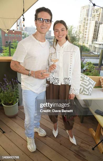 Oliver Proudlock and Emma Louise Connolly attend the Quatre Vin x Aerial Rooftop launch party at The Broadcaster on July 13, 2022 in London, England.