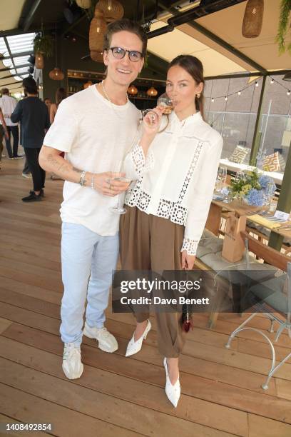 Oliver Proudlock and Emma Louise Connolly attend the Quatre Vin x Aerial Rooftop launch party at The Broadcaster on July 13, 2022 in London, England.