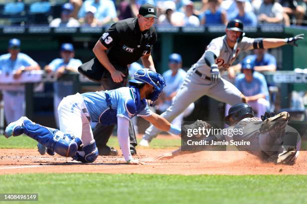 Jonathan Schoop of the Detroit Tigers is tagged out at home plate by catcher MJ Melendez of the Kansas City Royals while attempting to score during...