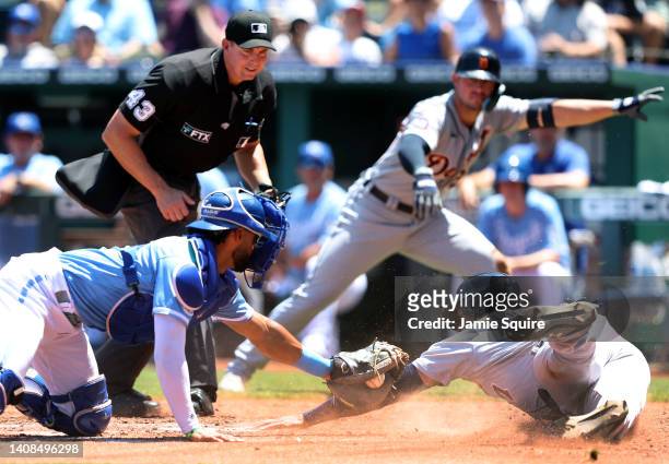 Jonathan Schoop of the Detroit Tigers is tagged out at home plate by catcher MJ Melendez of the Kansas City Royals while attempting to score during...