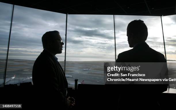 Mark Costanzo , construction project manager for SFO, and Doug Yakel, the airport's public information officer, takes in the 360-degree view of the...