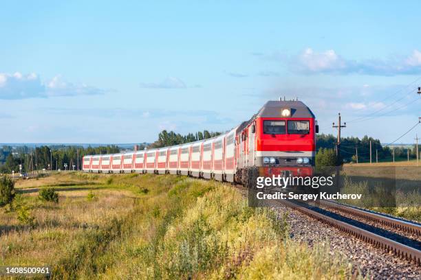 two powerful diesel locomotives with double-decker passenger train - intercity fotografías e imágenes de stock