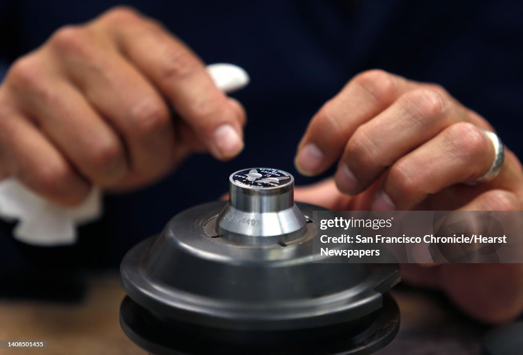 Pressman Gary Ruvo inspects a die for Sacajawea dollar coins at the United States Mint in San Francisco, Calif. on Wednesday, March 9. A limited release of 750,000 commemorative half-dollar coins to mark the 100th anniversary of the National Park Service