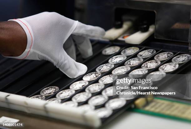 Rodney Kirby, a pressman at the United States Mint, strikes Kennedy half-dollar coins in San Francisco, Calif. On Wednesday, March 9. A limited...