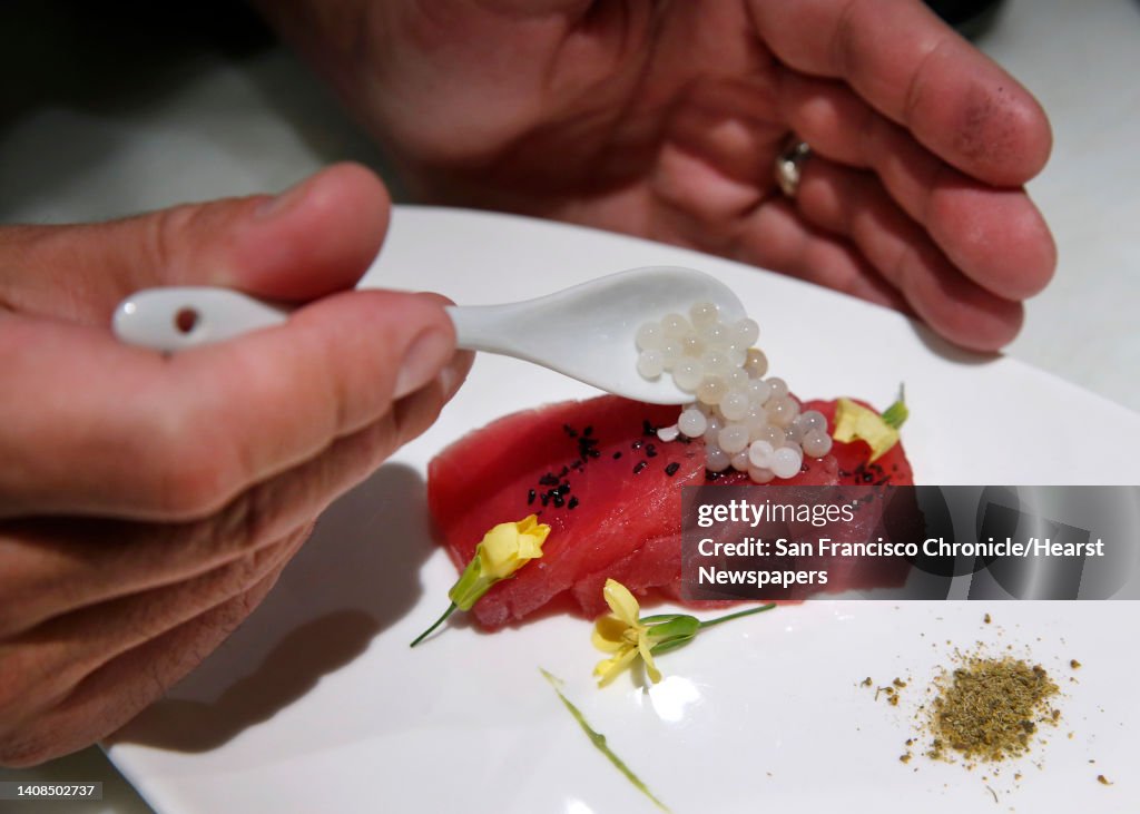 Matthew Dolan, co-owner and executive chef at Twenty Five Lusk, prepares escargot caviar and ahi tuna crudo with mustard blossoms, black salt and a green garlic mousse in San Francisco, Calif. on Saturday, March 19, 2016