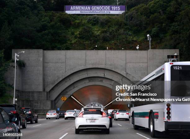 Bay Bridge commuters approach the Yerba Buena Island tunnel below a large banner about Armenian genocide in San Francisco, Calif. On Wednesday, April...